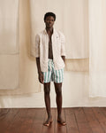 Ecru swim trunks with green stripes